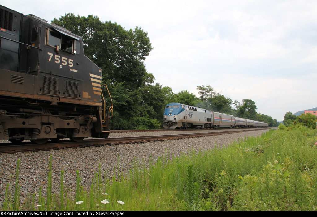Amtrak 124 takes train 07T west, while NS 7555 waits on the siding